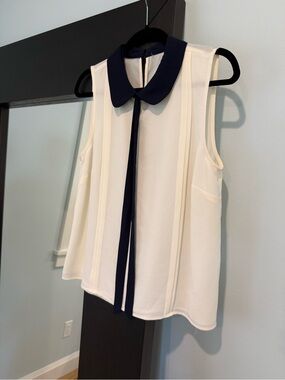 Sleeveless Ivory Blouse with Navy Contrast Peter Pan Collar and Tie